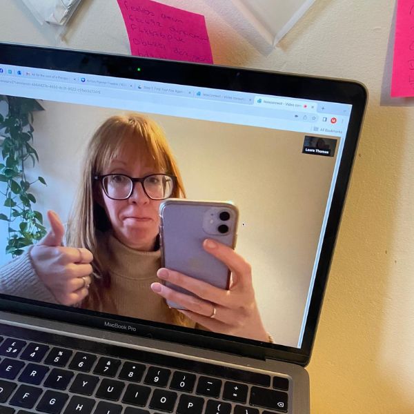 lady thumbs up on a laptop